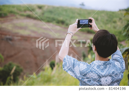 Man taking photo of beautiful mountain landscape with mobile phone Man taking photo of beautiful mountain landscape with mobile phone 81404196