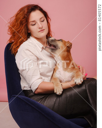 woman with puppy American Staffordshire Terrier posing in studio 81405572