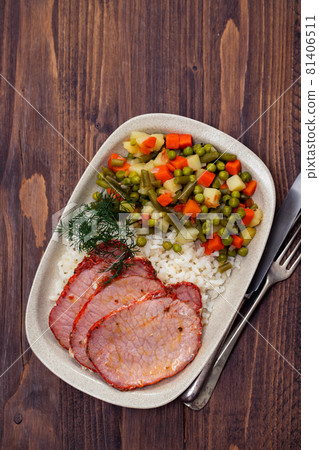 fried pork with boiled rice and vegetables on dish 81406511
