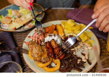 Young woman eating grilled steak in restaurant. Young woman eating grilled steak in restaurant. 81406696