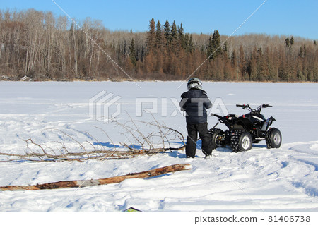 Pulling Firewood With a Quad to Make a Fire on the Ice Pulling Firewood With a Quad to Make a Fire on the Ice 81406738
