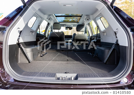 a huge car interior with the rear seats folded down. large luggage compartment of a family car. car folding seats and large volume empty car trunk and special storage compartment 81410580