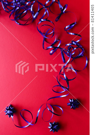 Blue shiny ribbon with gift bows on a red background. Blue shiny ribbon with gift bows on a red background. 81411405