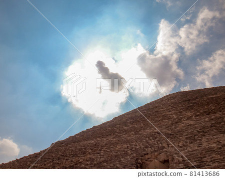 The sun over the clouds looking up through the Khufu pyramid 81413686