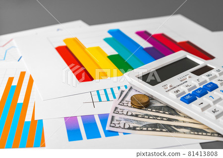 Business graphs paper and calculator on table 81413808