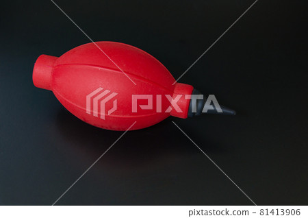 A red blower that blows away the dust from the camera A red blower that blows away the dust from the camera 81413906