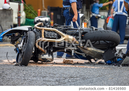 A motorcycle that collided with a passenger car at an intersection and was wrecked 81416980
