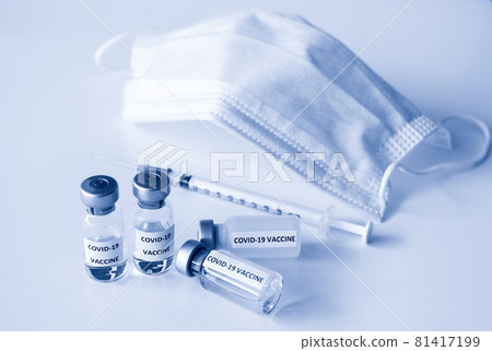 Covid-19 Prevention concept : vial of Covid-19 vaccine, 1 ml plastic syringe with needle and mask Covid-19 Prevention concept : vial of Covid-19 vaccine, 1 ml plastic syringe with needle and mask 81417199