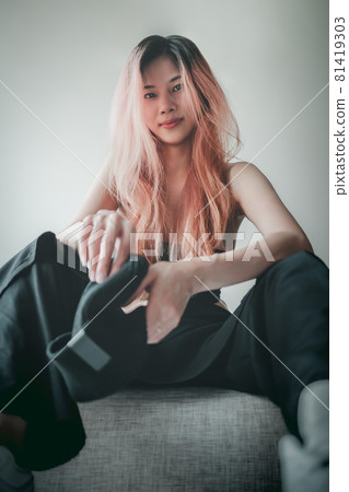 Asian Fashion model girl is posing on Sofa in an apartment for street fashion Asian Fashion model girl is posing on Sofa in an apartment for street fashion 81419303