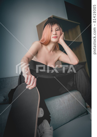 Asian sexy model girl with skateboard posing on Sofa in an apartment for street fashion. Asian sexy model girl with skateboard posing on Sofa in an apartment for street fashion. 81419305