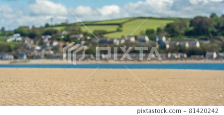 Panoramic shot of LLansteffan beach with sand and green fields with houses in southern Wales Panoramic shot of LLansteffan beach with sand and green fields with houses in southern Wales 81420242