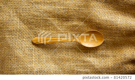 Beautiful wooden spoon isolated on canvas background. Concept. Beautiful wooden spoon isolated on canvas background. Concept. 81420572