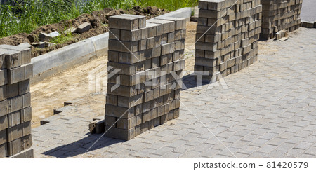 Pile of concrete cement cinder blocks at the construction site. Sidewalk construction and reconstruction. Beautiful grey background. Reconstruction concept image. Pile of concrete cement cinder blocks at the construction site. Sidewalk construction and reconstruction. Beautiful grey background. Reconstruction concept image. 81420579