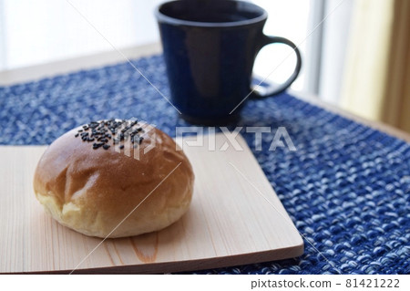 Anpan and drink on a blue place mat Anpan and drink on a blue place mat 81421222