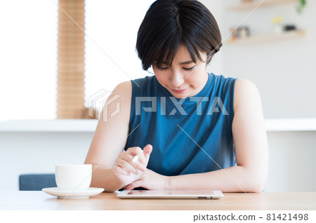 一位女士使用觸控筆操作平板設備 81421498