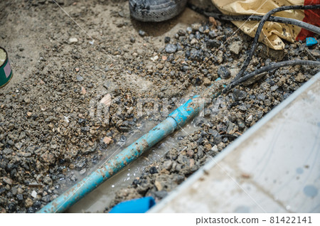 Demolition fixing leak sewerage pipe on the floor in bathroom 81422141