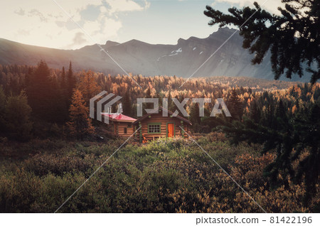 Wooden huts with rocky mountains and sunshine on autumn deep forest in the morning at Assiniboine provincial park Wooden huts with rocky mountains and sunshine on autumn deep forest in the morning at Assiniboine provincial park 81422196
