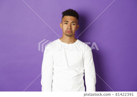 Portrait if silly african-american guy whining, begging for something, crying and looking sad at camera, standing over purple background Portrait if silly african-american guy whining, begging for something, crying and looking sad at camera, standing over purple background 81422391