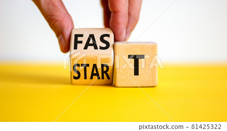 Time to fast start symbol. Businessman turns a wooden cube with words 'fast start'. Beautiful yellow table, white background, copy space. Business and fast start concept. 81425322