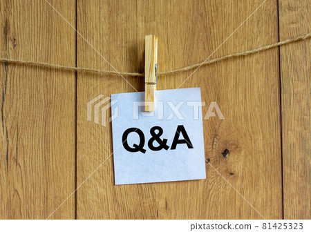 Questions and answers symbol. White paper. Words 'Q and A, Questions and answers'. Beautiful wooden background. Business and Q and A, questions and answers concept, copy space. 81425323