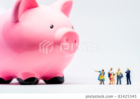 Miniature people. Two adults showing giant piggy bank to a boy 81425345