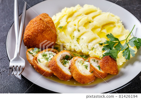Chicken Kiev served with potato mash on a plate 81426194
