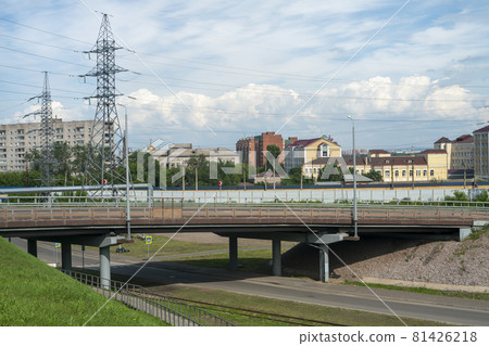 Massive car overpass in summer near the hills with houses. 81426218