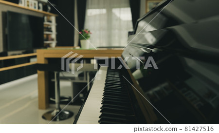 Piano keyboard with blur background home living room with modern interior decoration 81427516