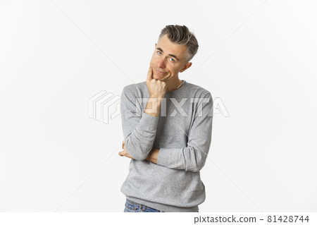 Portrait of bored and unamused middle-aged man in grey sweater, leaning on hand and looking at camera reluctant, standing sad over white background Portrait of bored and unamused middle-aged man in grey sweater, leaning on hand and looking at camera reluctant, standing sad over white background 81428744