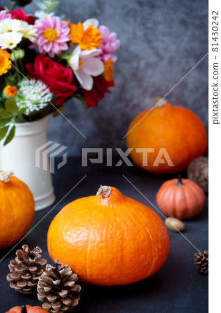 Pumpkins. Autumn creative flatlay, dark background with candles, autumn flowers, pine cones and pumpkins. 81430242