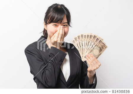 Young business woman holding money 81430836