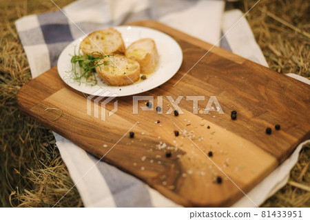 Healthy vegan breakfast concept. Whole wheat bread with olive oil. Sliced baguette on wooden table. Hay Healthy vegan breakfast concept. Whole wheat bread with olive oil. Sliced baguette on wooden table. Hay 81433951