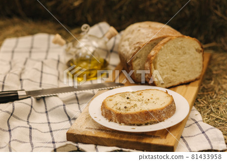 Healthy vegan breakfast concept. Whole wheat bread with olive oil. Sliced bread on wooden table. Hay Healthy vegan breakfast concept. Whole wheat bread with olive oil. Sliced bread on wooden table. Hay 81433958