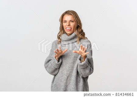 Image of disgusted and disturbed blond girl sticking tongue and stepping back from something, rejecting bad offer, standing over white background Image of disgusted and disturbed blond girl sticking tongue and stepping back from something, rejecting bad offer, standing over white background 81434661