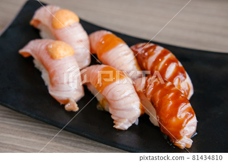 Set of Salmon aburi sushi with sauce on plate 81434810