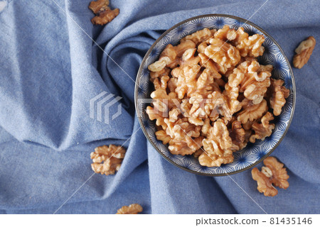 walnut on a plate on table , close up. 81435146