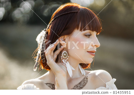Indian american pretty woman with bare shoulders and tattoos, posing outdoor in the nature Indian american pretty woman with bare shoulders and tattoos, posing outdoor in the nature 81435951