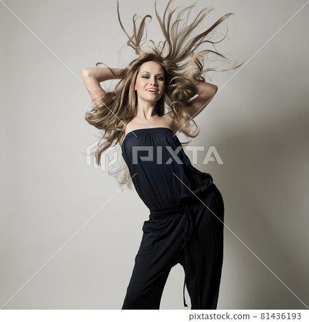 Portrait of charming dancing girl. Beautiful lady on gray background 81436193