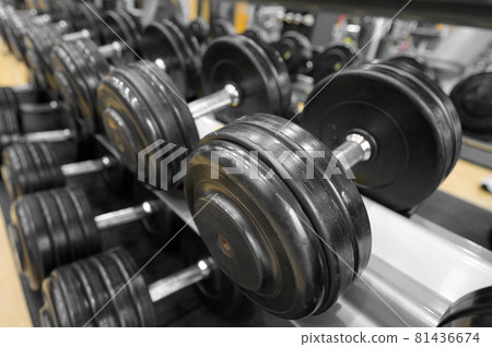 Close up of dumbbells. Gym interior. 81436674