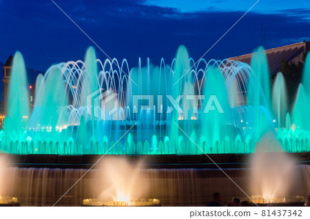 Blue water in Magic Fountain of Montjuic at night in Barcelona, Spain. 81437342