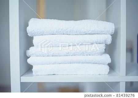 Five white towels on the shelf at beauty salon. 81439276