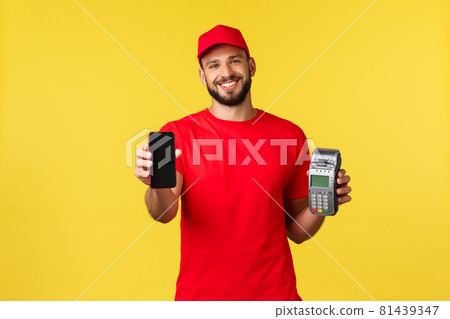 Contactless payment, online delivery, internet shopping concept. Nice courier in red uniform t-shirt and cap, showing customer smartphone app and paying terminal POS, yellow background Contactless payment, online delivery, internet shopping concept. Nice courier in red uniform t-shirt and cap, showing customer smartphone app and paying terminal POS, yellow background 81439347