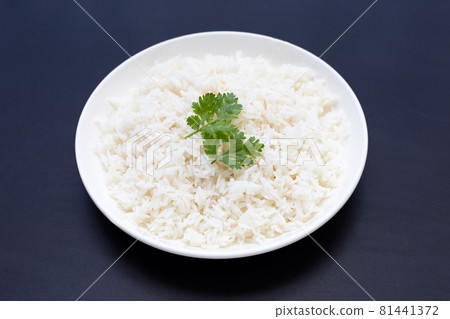 Dish of rice on dark background. Dish of rice on dark background. 81441372