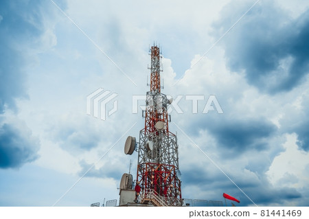 Large telecommunication tower against sky and clouds in background 81441469