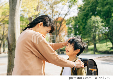 A boy who is pleased to be praised by his mother A boy who is pleased to be praised by his mother 81441789