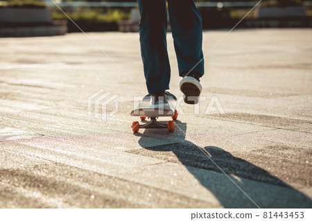 Skateboarder skateboarding outdoors in city 81443453