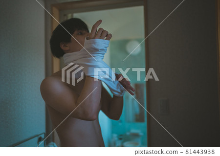 A man after a bath wearing a T-shirt 81443938