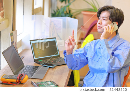 Electrical engineer talking on the phone while remembering 1 81448320