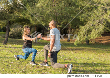 Fitness couple exercising by holding hands in the park Fitness couple exercising by holding hands in the park 81450199