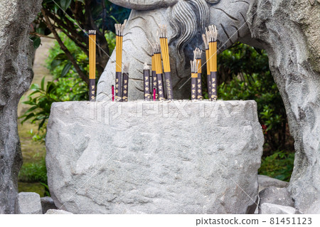 NEW TAIPEI CITY, TAIWAN - JANUARY 27, 2012:  Incense sticks burning inside the pot at Guan Dao Guan Ying Buddhist Temple 81451123